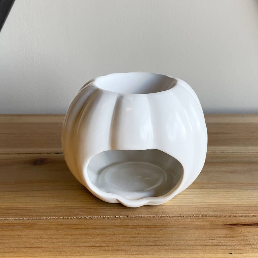 Witte pompoen kaars en oliebrander